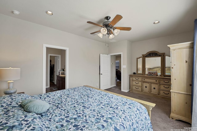 carpeted bedroom featuring ensuite bath and ceiling fan