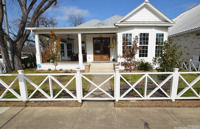 view of front of home with french doors, ceiling fan, and covered porch