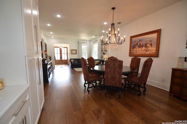 dining room featuring dark hardwood / wood-style floors, a chandelier, and french doors