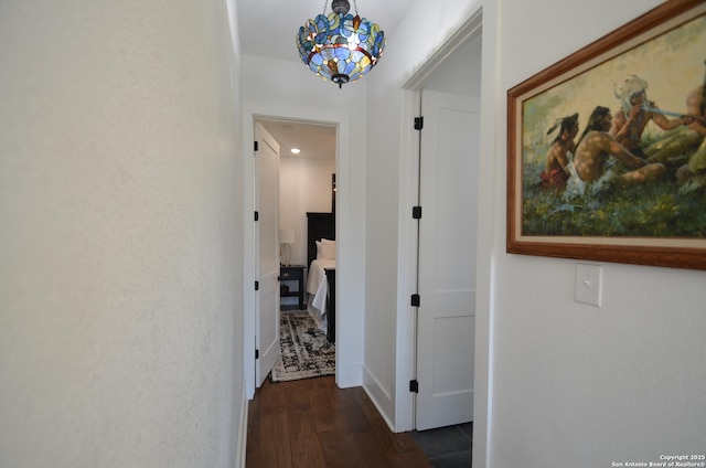 corridor featuring dark hardwood / wood-style flooring