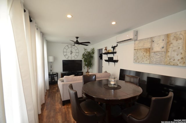 dining area featuring an AC wall unit, dark hardwood / wood-style floors, and ceiling fan