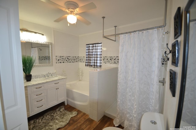 full bathroom featuring shower / bath combination with curtain, hardwood / wood-style flooring, vanity, ceiling fan, and toilet