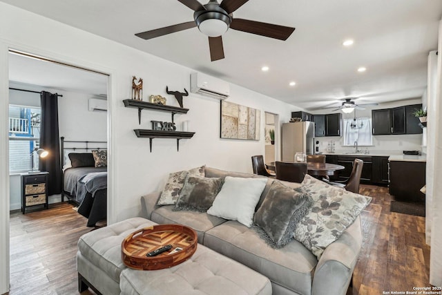 living room featuring sink, dark wood-type flooring, and a wall mounted AC