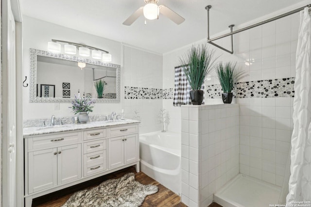 bathroom with ceiling fan, vanity, separate shower and tub, and hardwood / wood-style floors