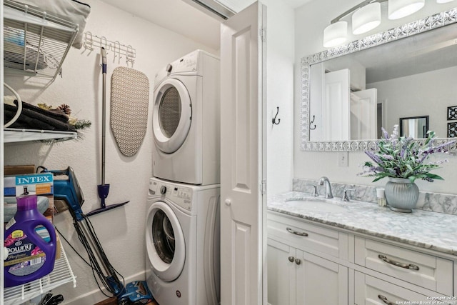 laundry room featuring stacked washer and dryer and sink