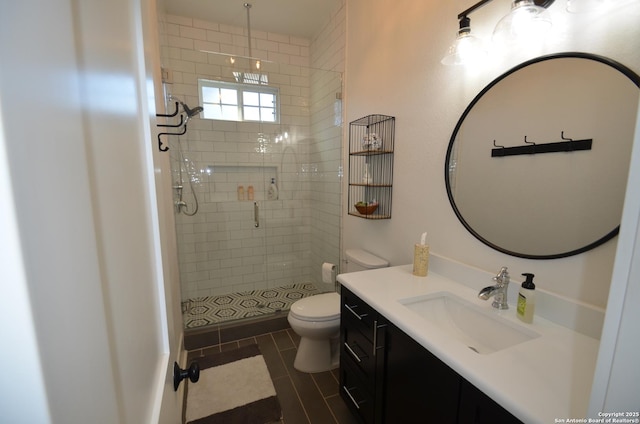 bathroom with vanity, tile patterned flooring, toilet, and walk in shower