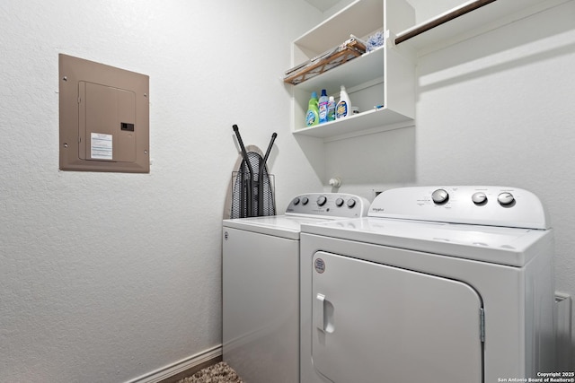 laundry area featuring washing machine and clothes dryer and electric panel