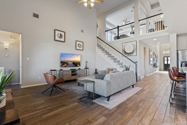 living room featuring hardwood / wood-style flooring and ceiling fan