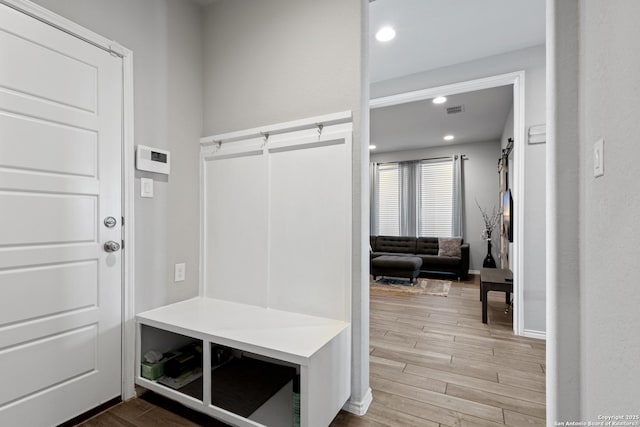 mudroom with hardwood / wood-style floors