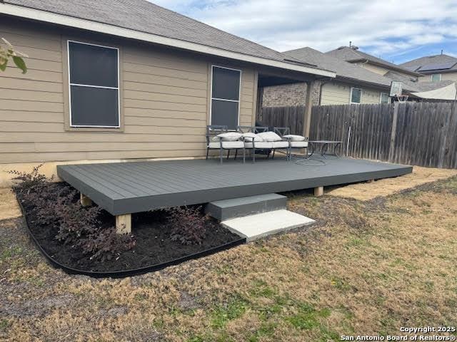 deck with a yard and outdoor lounge area