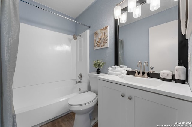 full bathroom with washtub / shower combination, vanity, toilet, and hardwood / wood-style floors