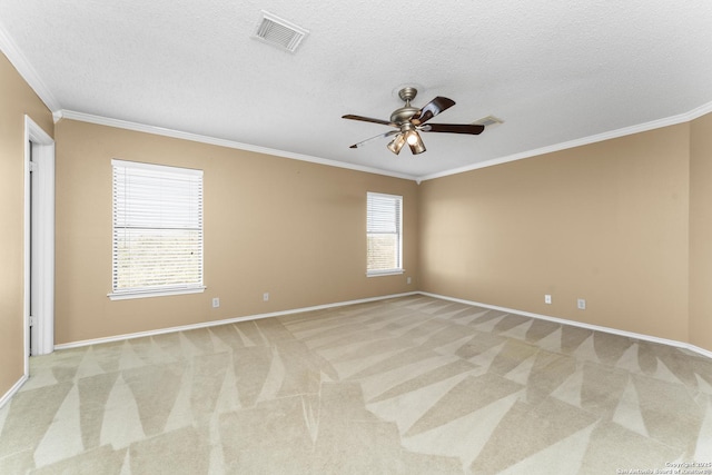 carpeted empty room with a textured ceiling, ornamental molding, and ceiling fan