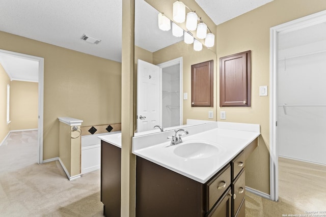 bathroom featuring vanity and a textured ceiling