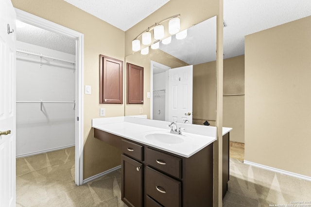 bathroom with vanity and a textured ceiling