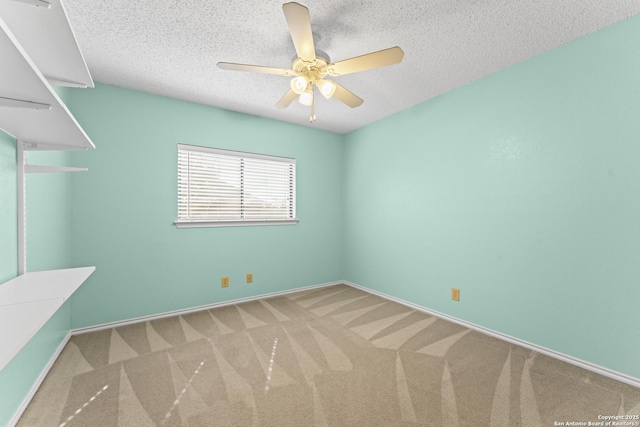 empty room featuring ceiling fan, carpet, and a textured ceiling