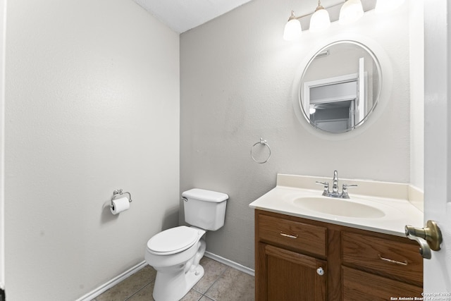 bathroom with vanity, tile patterned flooring, and toilet