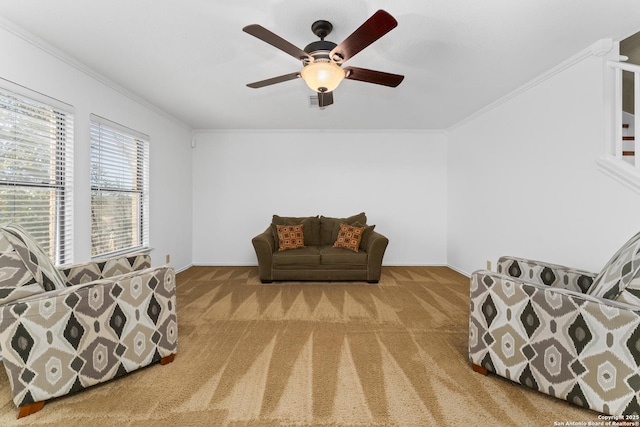 sitting room featuring crown molding, ceiling fan, and carpet