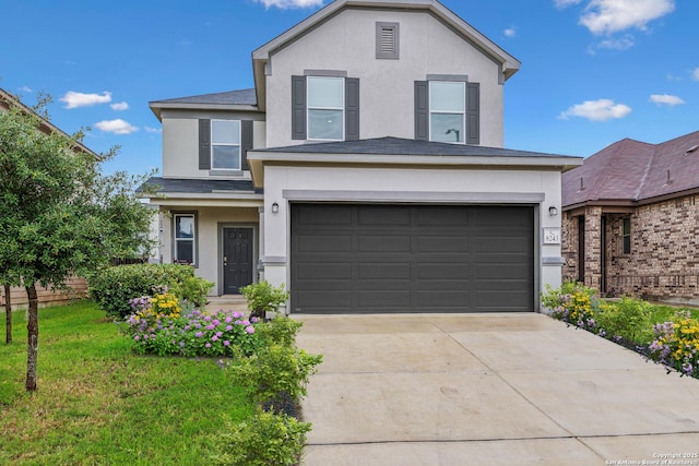 view of front property featuring a garage and a front yard