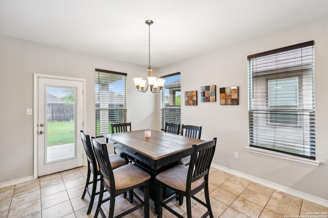 dining room featuring light tile patterned flooring and a chandelier