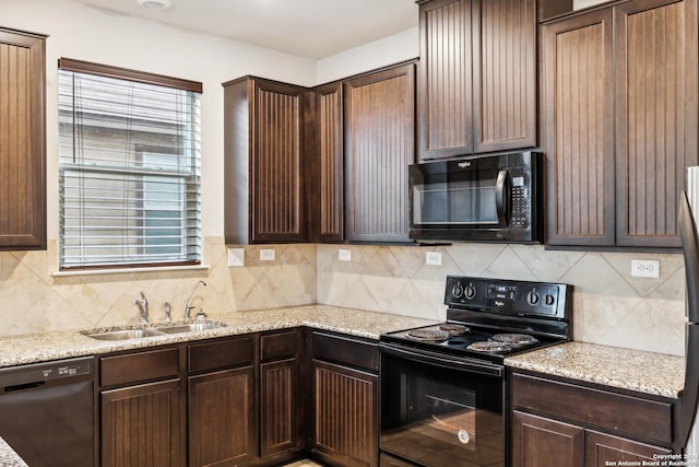 kitchen featuring dark brown cabinets, sink, backsplash, and black appliances