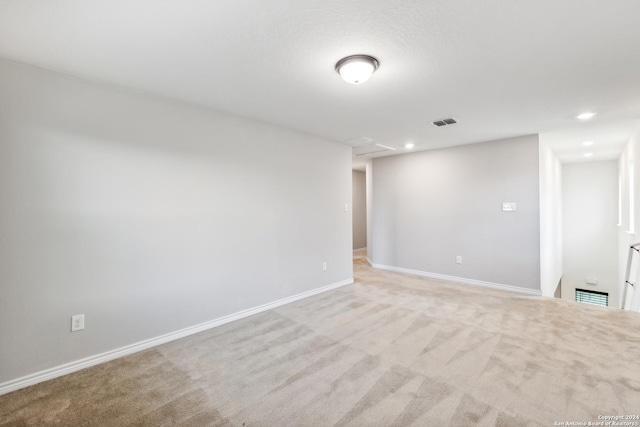 unfurnished room featuring light carpet