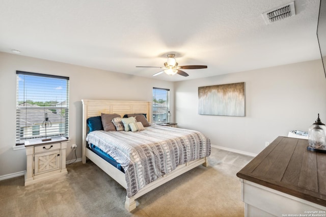 bedroom with ceiling fan and carpet flooring