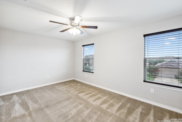 empty room featuring carpet flooring and ceiling fan