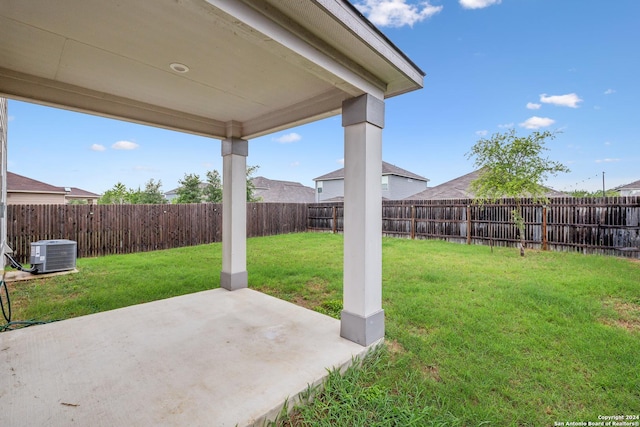 view of yard with central AC unit and a patio