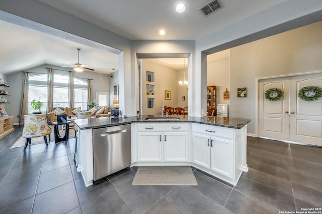 kitchen with sink, dishwasher, white cabinetry, ceiling fan with notable chandelier, and dark stone counters