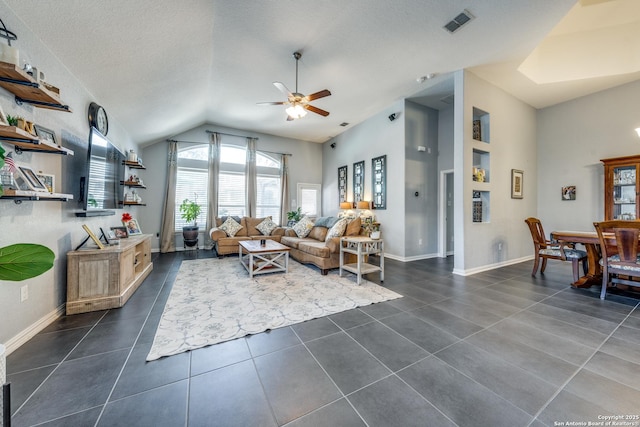 tiled living room featuring lofted ceiling, a textured ceiling, and ceiling fan