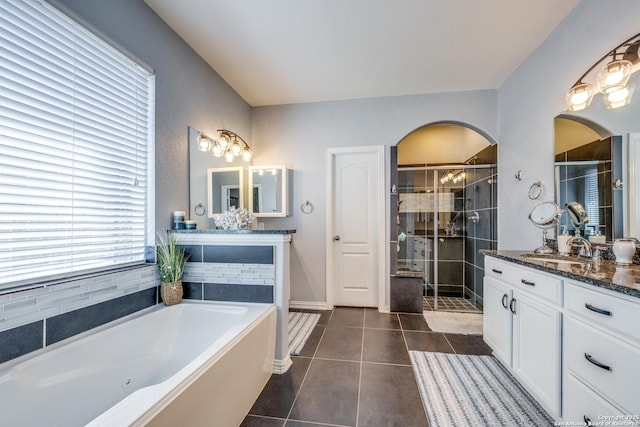 bathroom with tile patterned flooring, vanity, and separate shower and tub