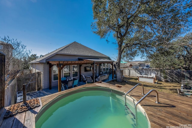 view of swimming pool with a deck