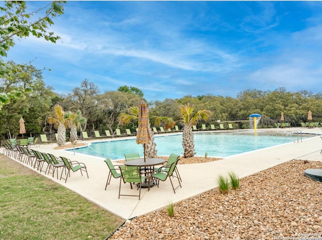 view of pool with pool water feature and a patio