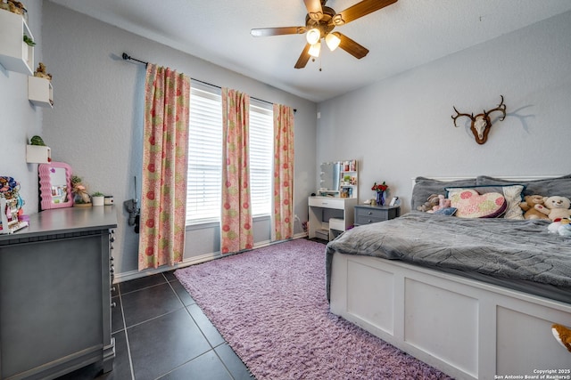 tiled bedroom featuring ceiling fan