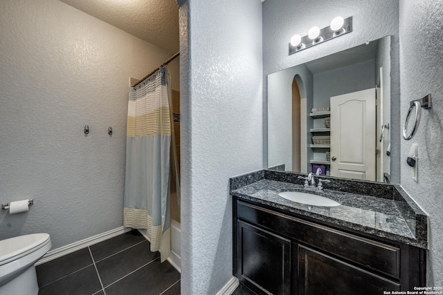 full bathroom with tile patterned flooring, vanity, shower / bath combo with shower curtain, and toilet