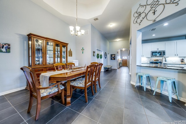 tiled dining room with a chandelier