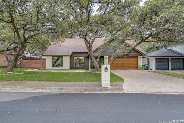 view of front of home featuring a garage and a front yard