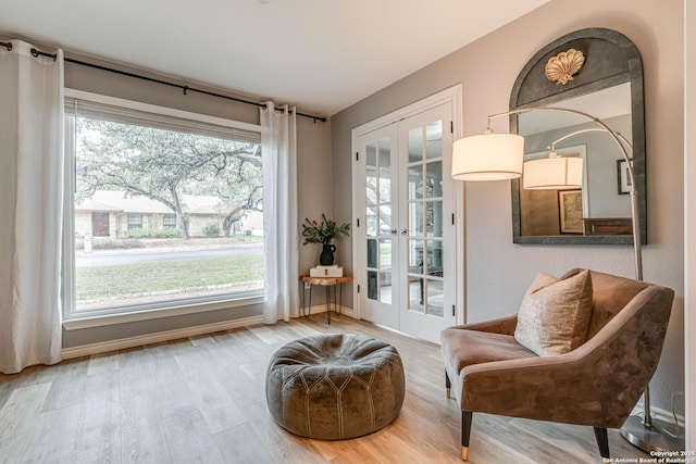 sitting room with wood-type flooring and french doors