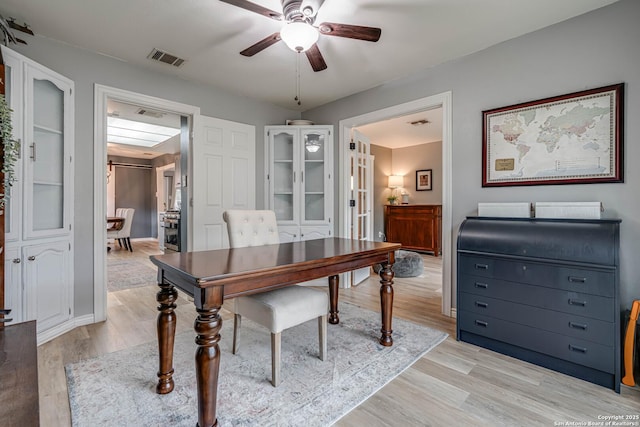 office with ceiling fan and light wood-type flooring