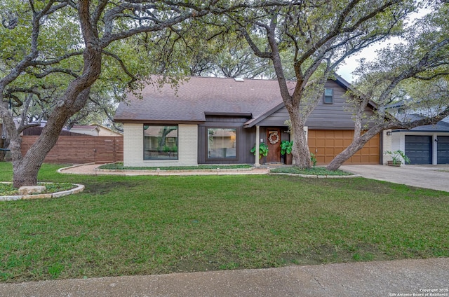 view of front of home with a garage and a front lawn