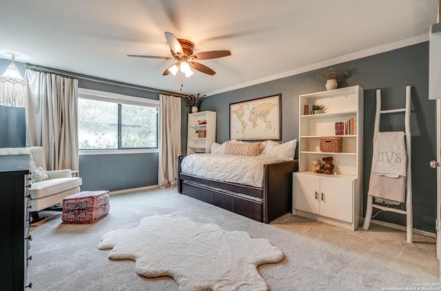 bedroom with crown molding, light colored carpet, and ceiling fan