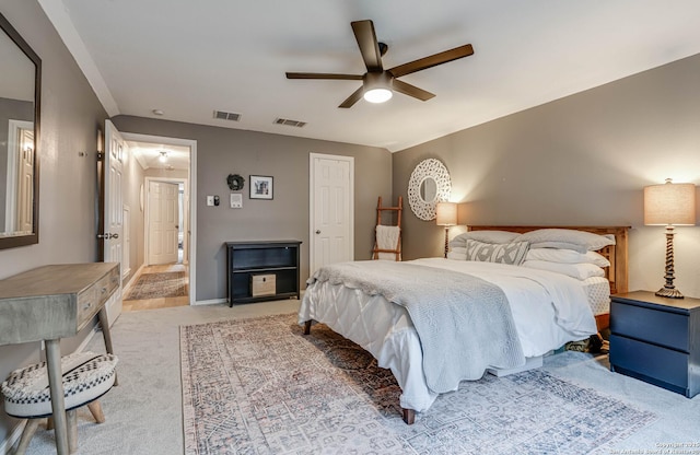 bedroom with ceiling fan and light carpet