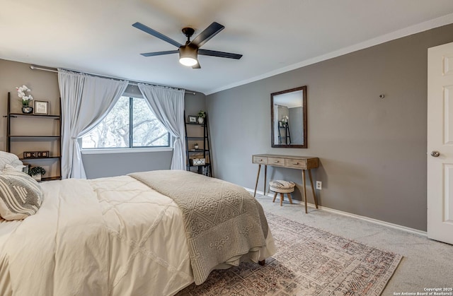 carpeted bedroom featuring crown molding and ceiling fan