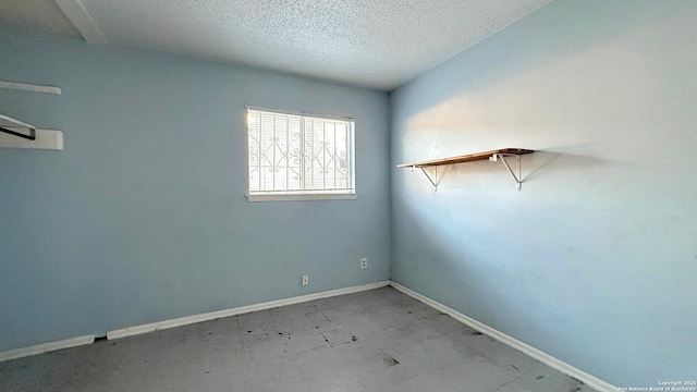 empty room featuring a textured ceiling