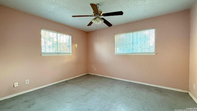 spare room featuring ceiling fan and a textured ceiling