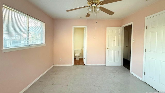 unfurnished bedroom with connected bathroom and ceiling fan