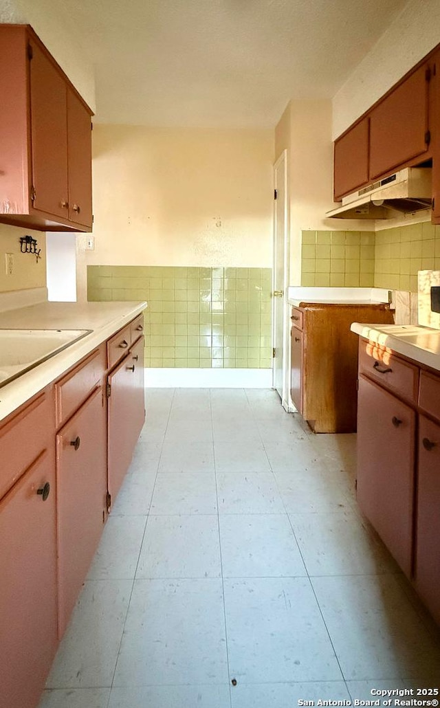 kitchen featuring tile walls and light tile patterned floors