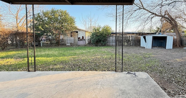 view of yard featuring a storage unit and a patio