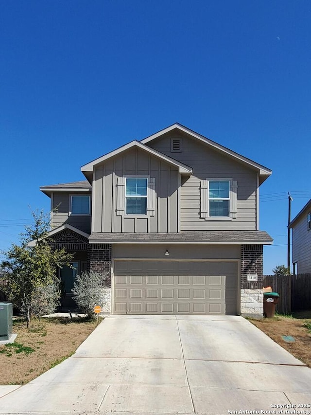 view of front of house featuring cooling unit and a garage