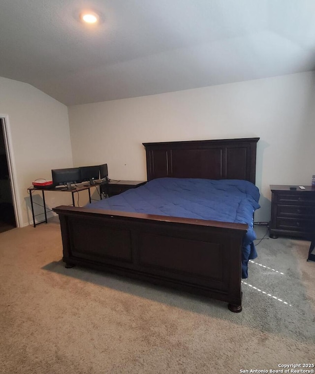 carpeted bedroom with vaulted ceiling